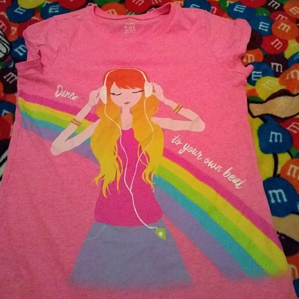 A pink shirt with a girl drawn in the shirt